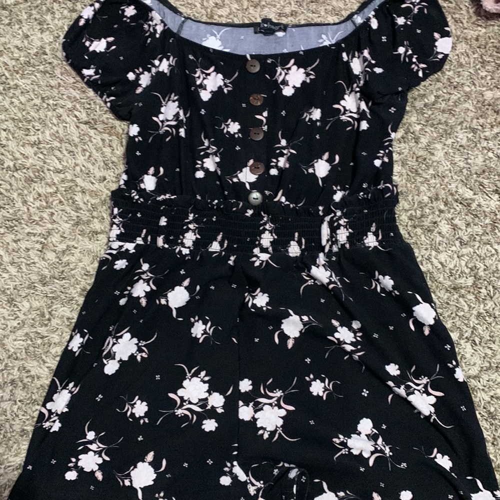 A black romper with light pink roses